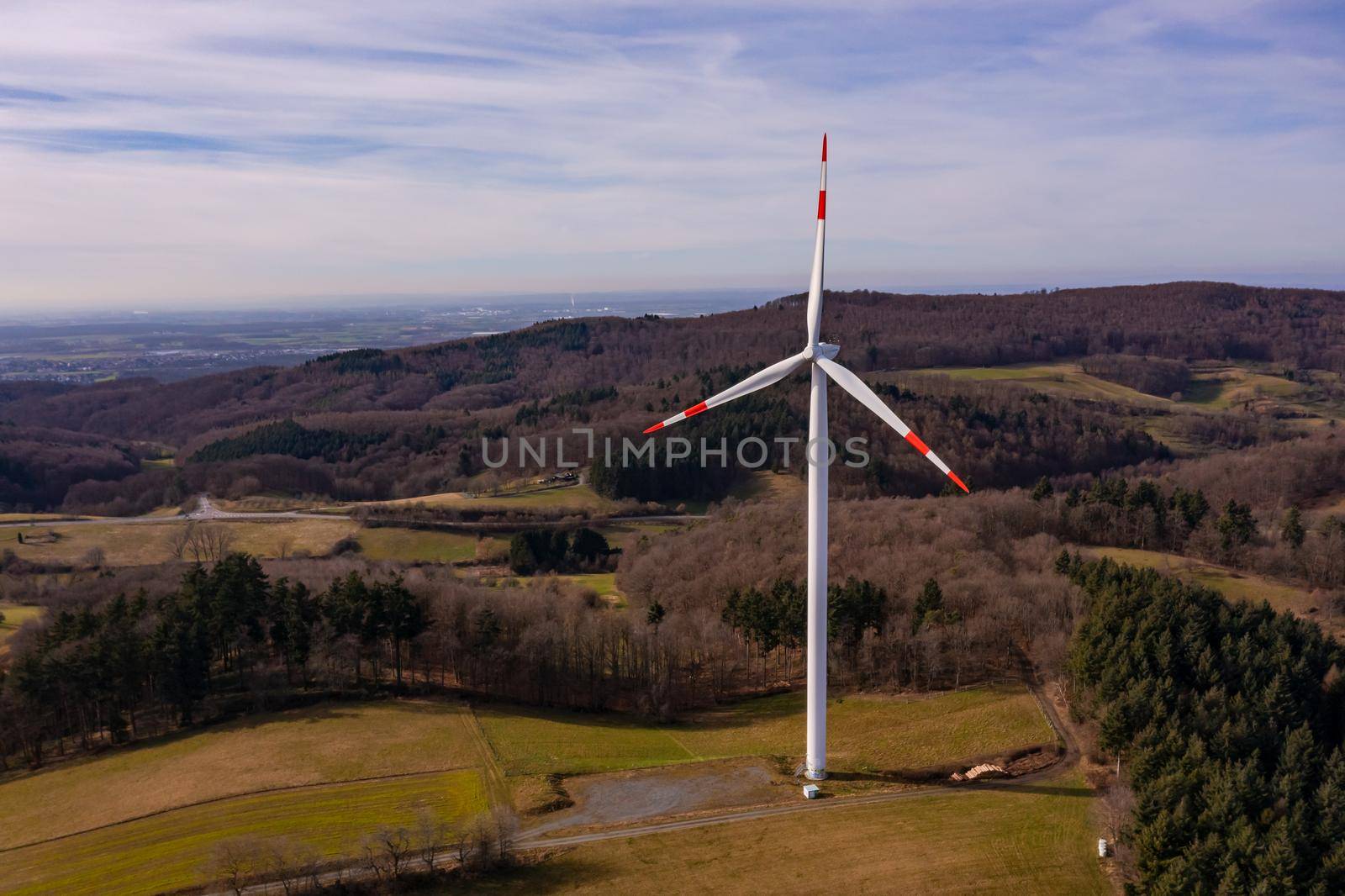 Aerial view from a drone perspective of a wind turbine with a panorama and view of the Odenwald