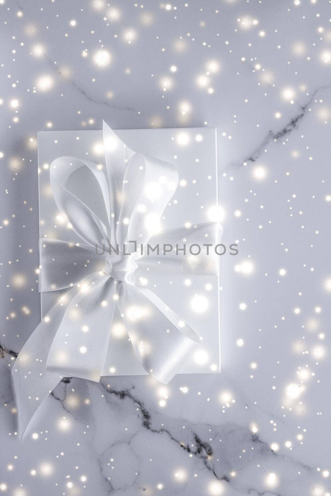 New Years Eve celebration, winter decoration and Valentines Day presents concept - Luxury holiday gifts with white silk bow and ribbons on marble background, Christmas time surprise