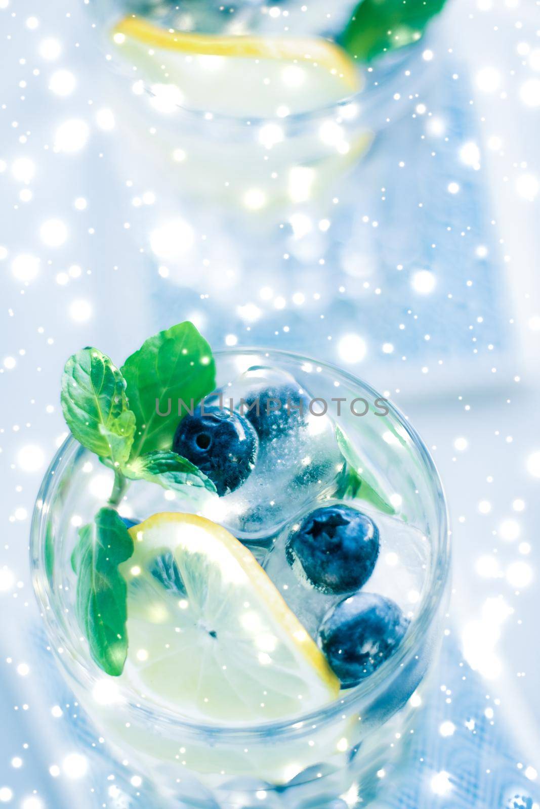 Cold icy drink, luxury bar and New Years Eve party celebration concept - Winter holiday cocktail with ice and glowing snow on background, Christmas time menu recipe