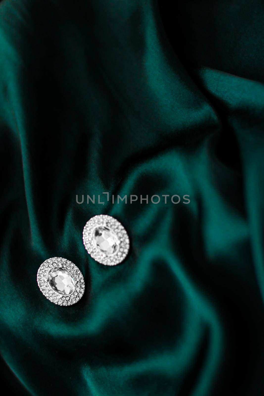 Luxury diamond earrings on dark emerald green silk, holiday glamour jewelery present by Anneleven