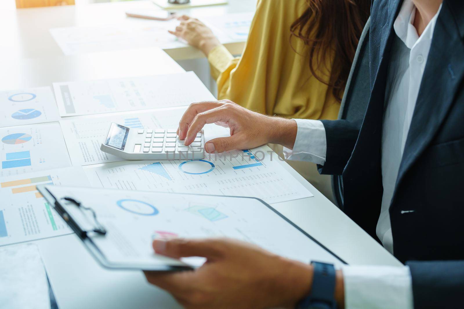 A male businessman or accountant is using the current year profitable investment budget calculator to calculate the IRS.