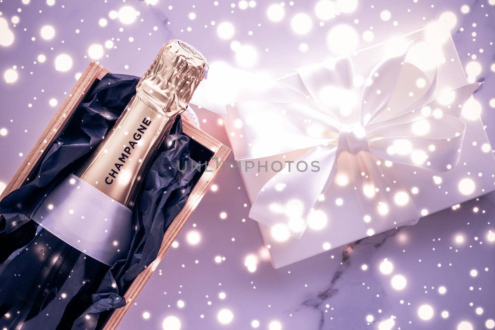 Champagne bottle and gift box on purple holiday glitter, New Years, Christmas, Valentines Day, winter present and luxury product packaging for beverage brand by Anneleven