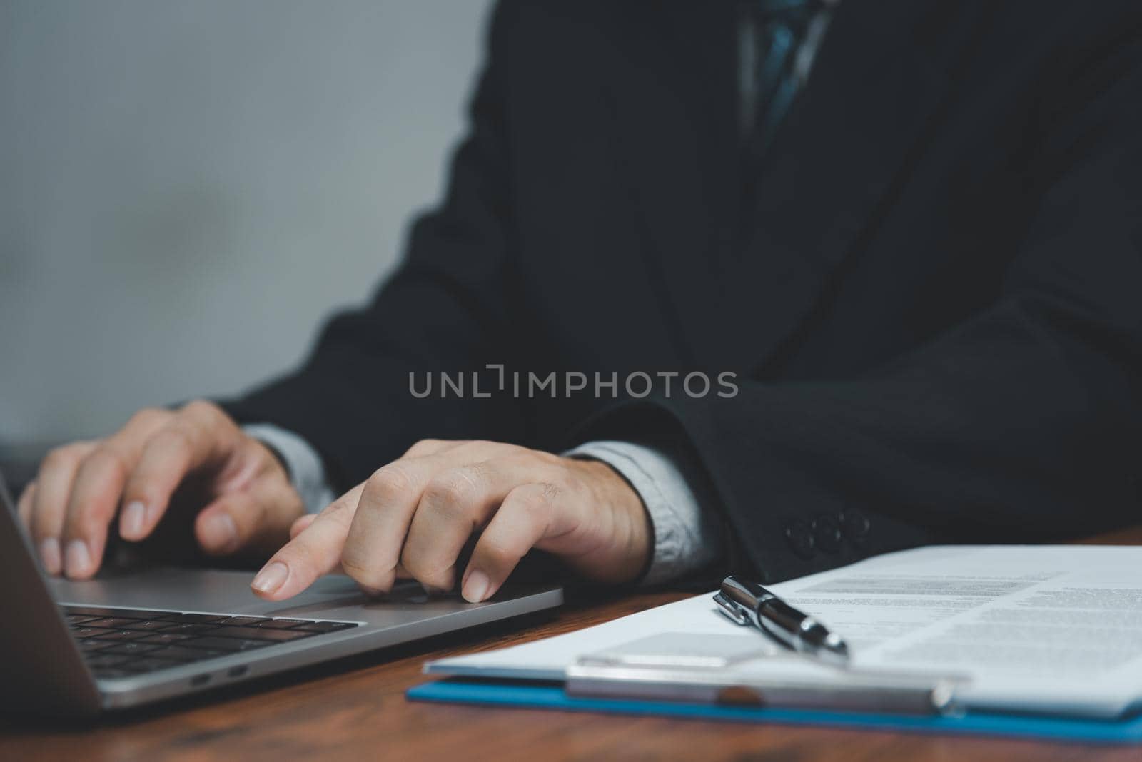 Businessman hand work on keyboard laptop computer at office table close up.business and technology concept. by aoo3771