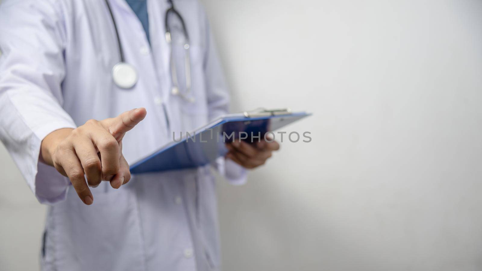 Doctor pressing button on virtual screen on background copy space for text.