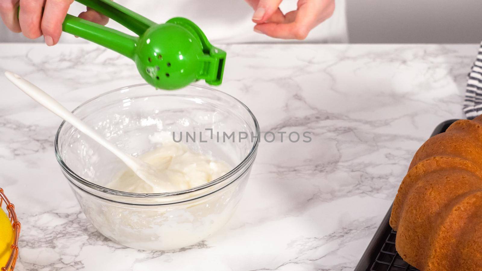Step by step. Mixing ingredients in a glass mixing bowl to prepare lemon glaze for a lemon bundt cake.