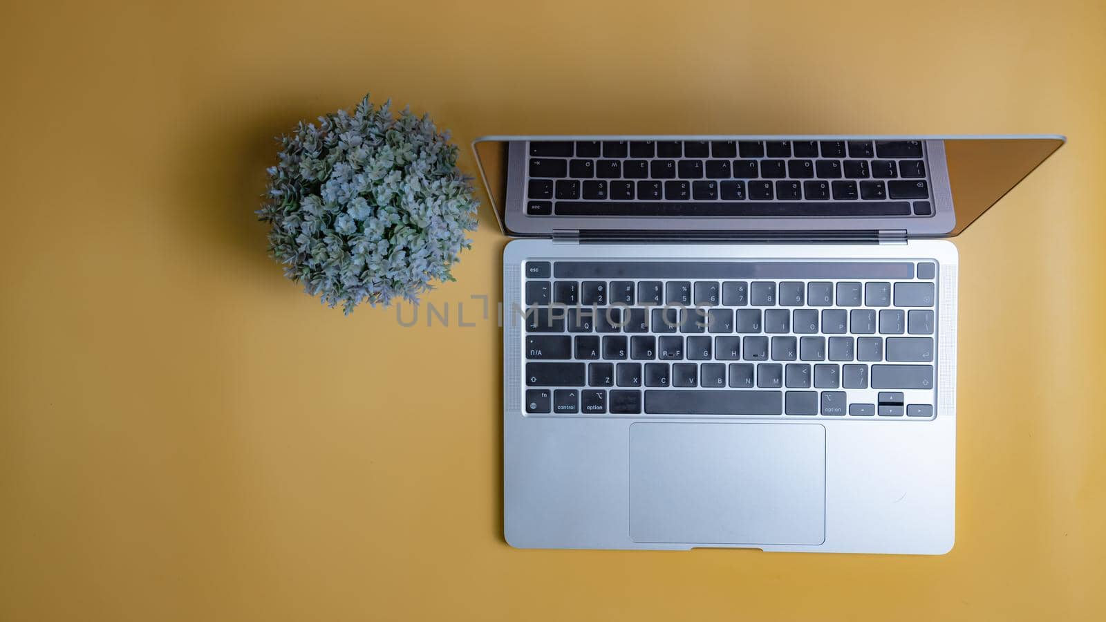 computer laptop on yellow background. Copy space