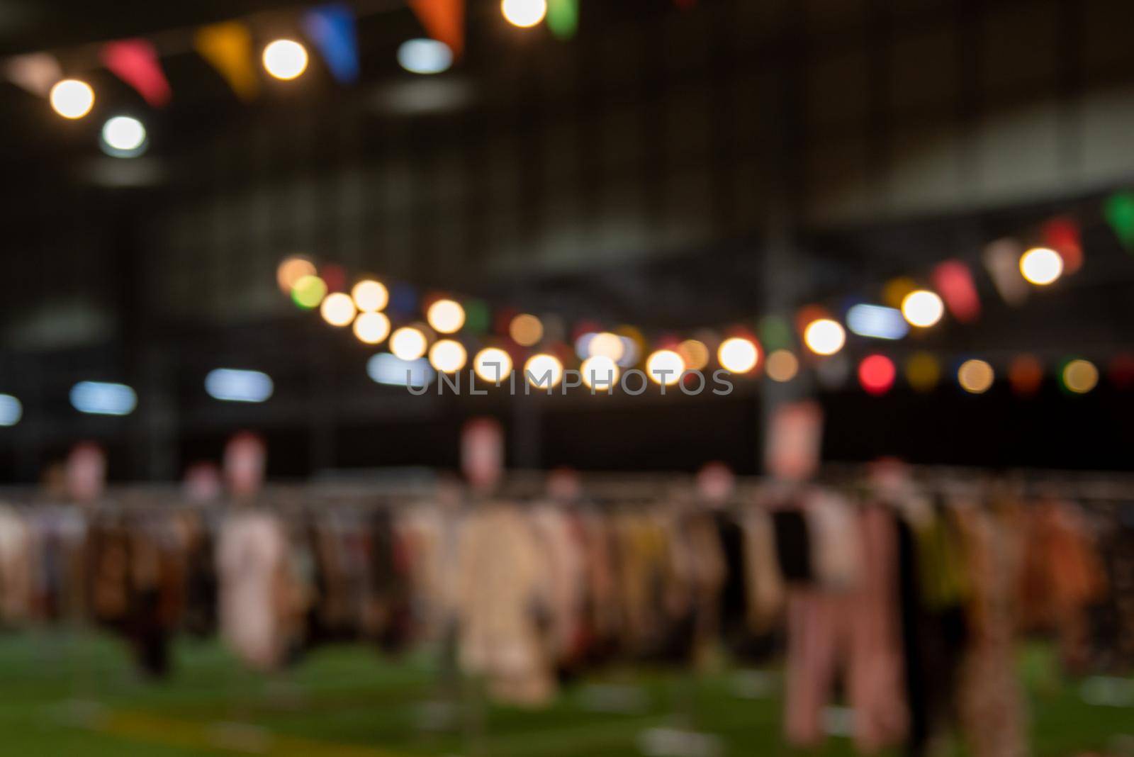 blurred image of night market festival people walking on road with light bokeh for background. by aoo3771