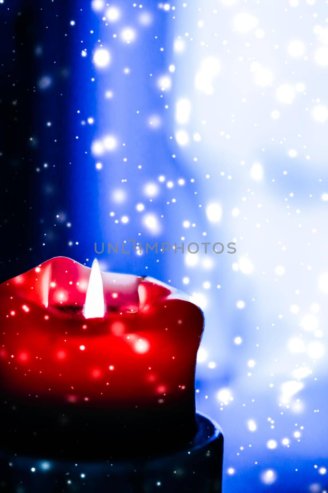 Happy holidays, greeting card and winter season concept - Red holiday candle on blue sparkling snowing background, luxury branding design for Christmas, New Years Eve and Valentines Day