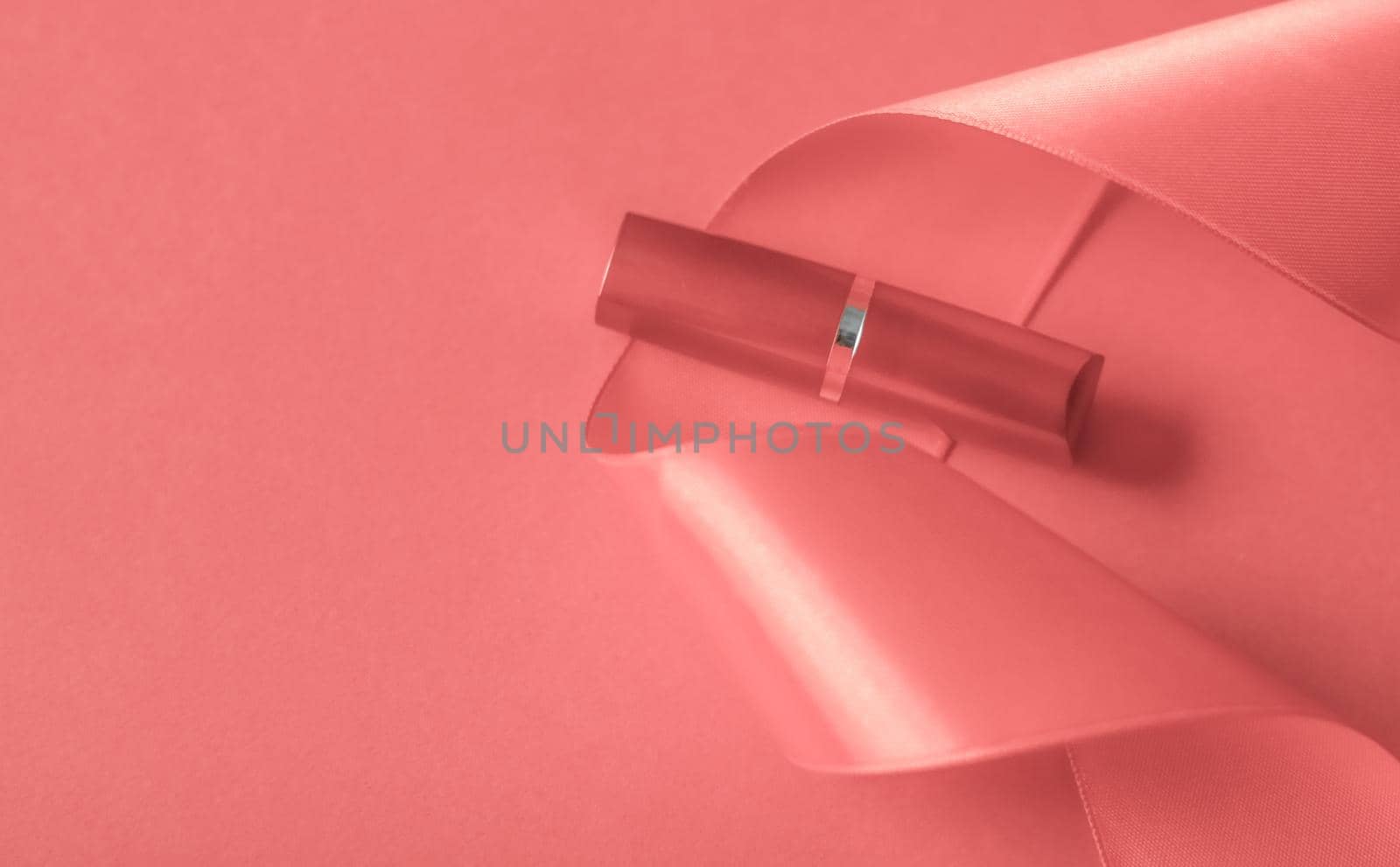 Cosmetic branding, glamour lip gloss and shopping sale concept - Luxury lipstick and silk ribbon on coral holiday background, make-up and cosmetics flatlay for beauty brand product design