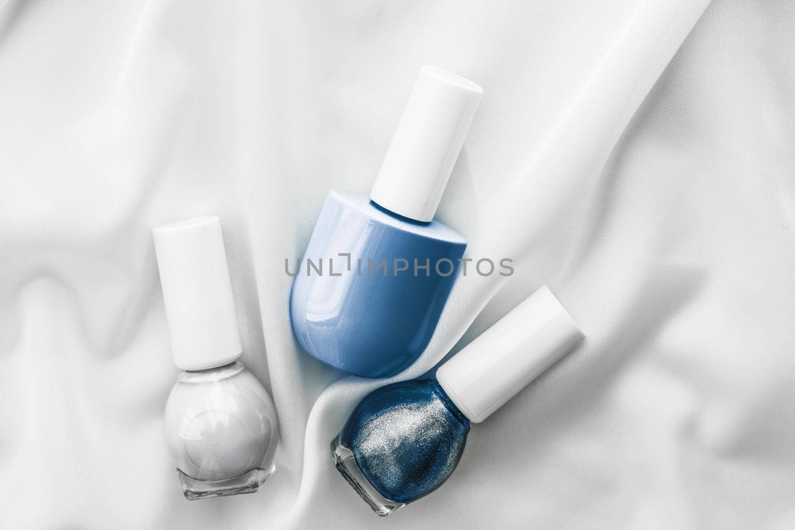 Cosmetic branding, salon and glamour concept - Nail polish bottles on silk background, french manicure products and nailpolish make-up cosmetics for luxury beauty brand and holiday flatlay art design