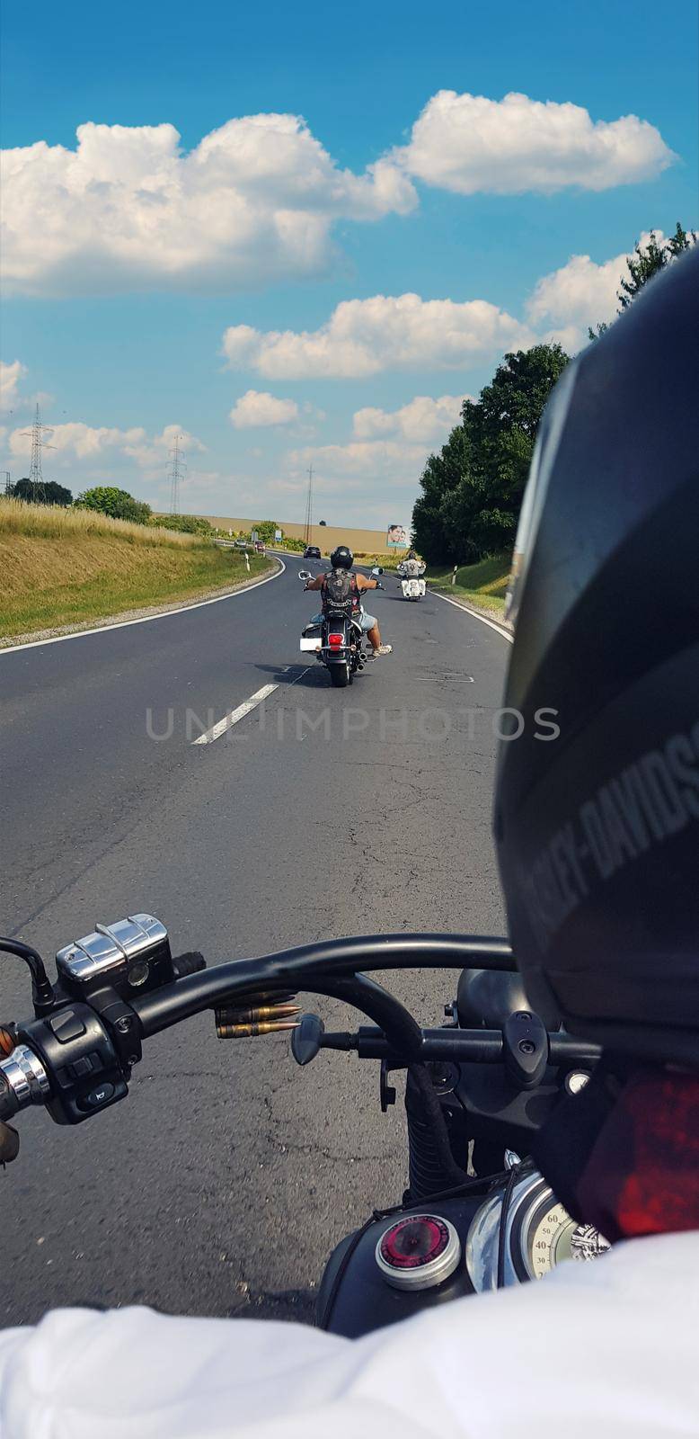 Snapshoot while riding a motorcycle on the road, blue sky by banate