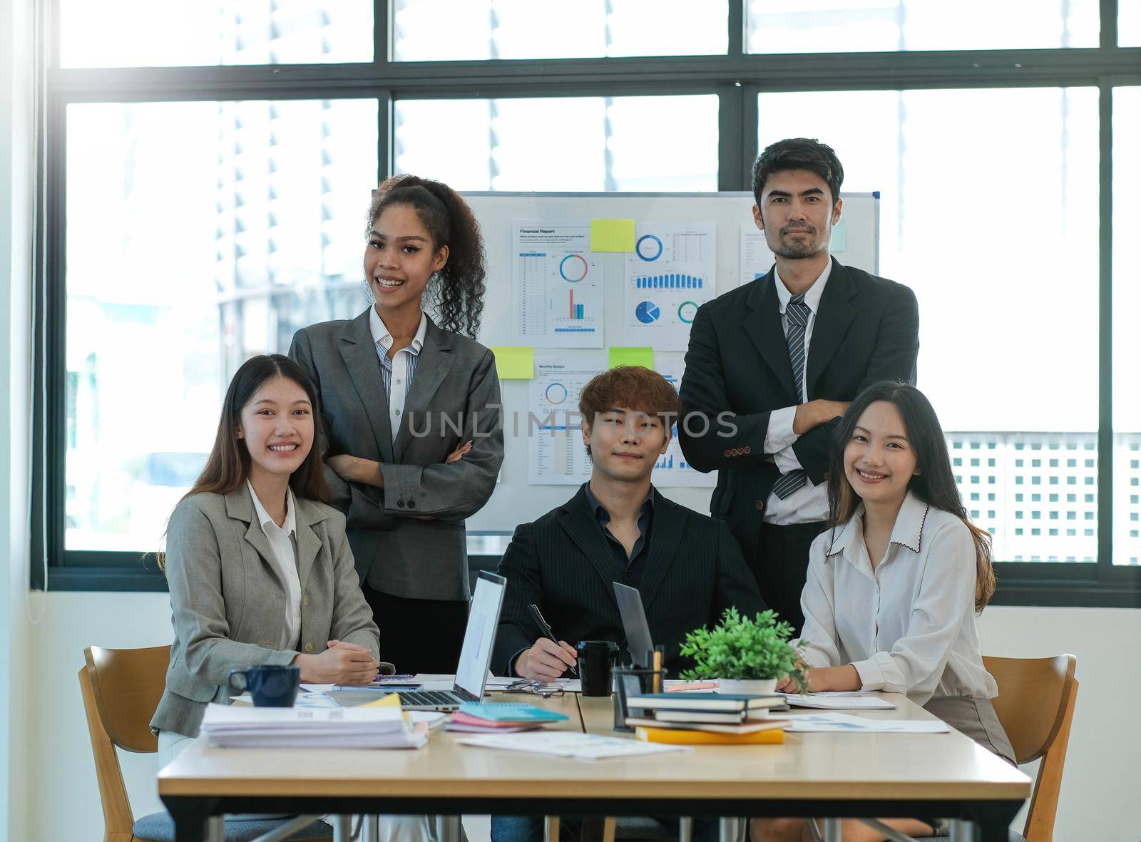 Group of asian young creative happy enjoy laugh smile and great success emotion teamwork people business startup entrepreneur casual brainstorm business meeting office background by wichayada
