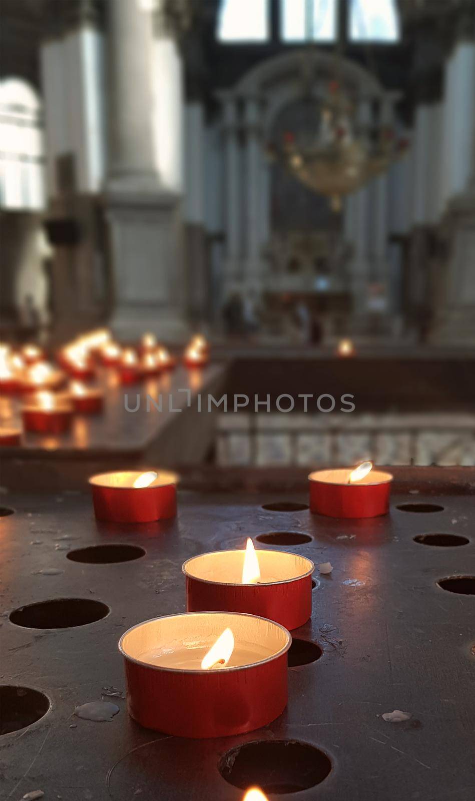 Red small candles with church dark background. High quality photo