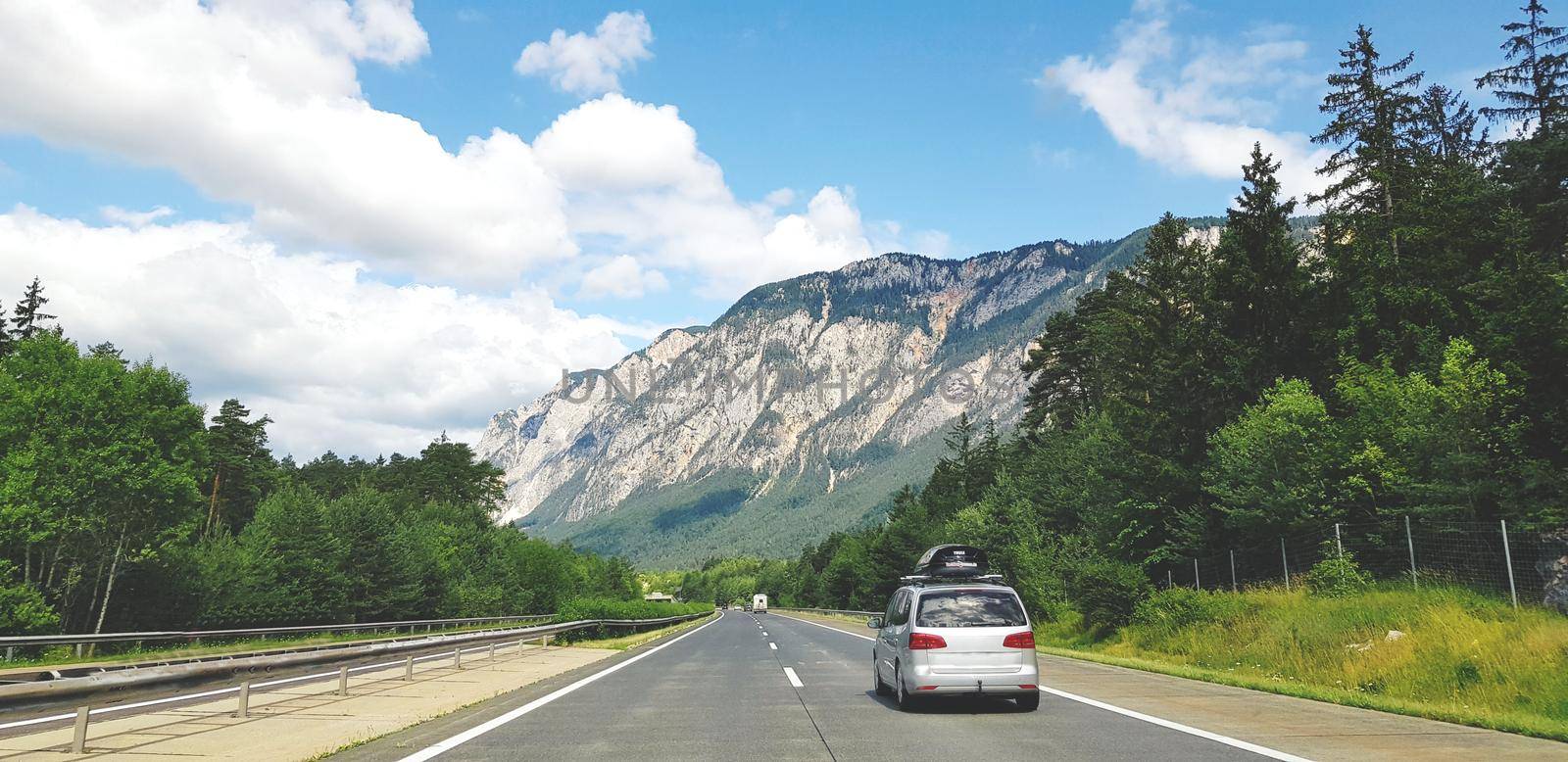 Going to Family Vacations with a Car, beatiful mountain landscape background. High quality photo