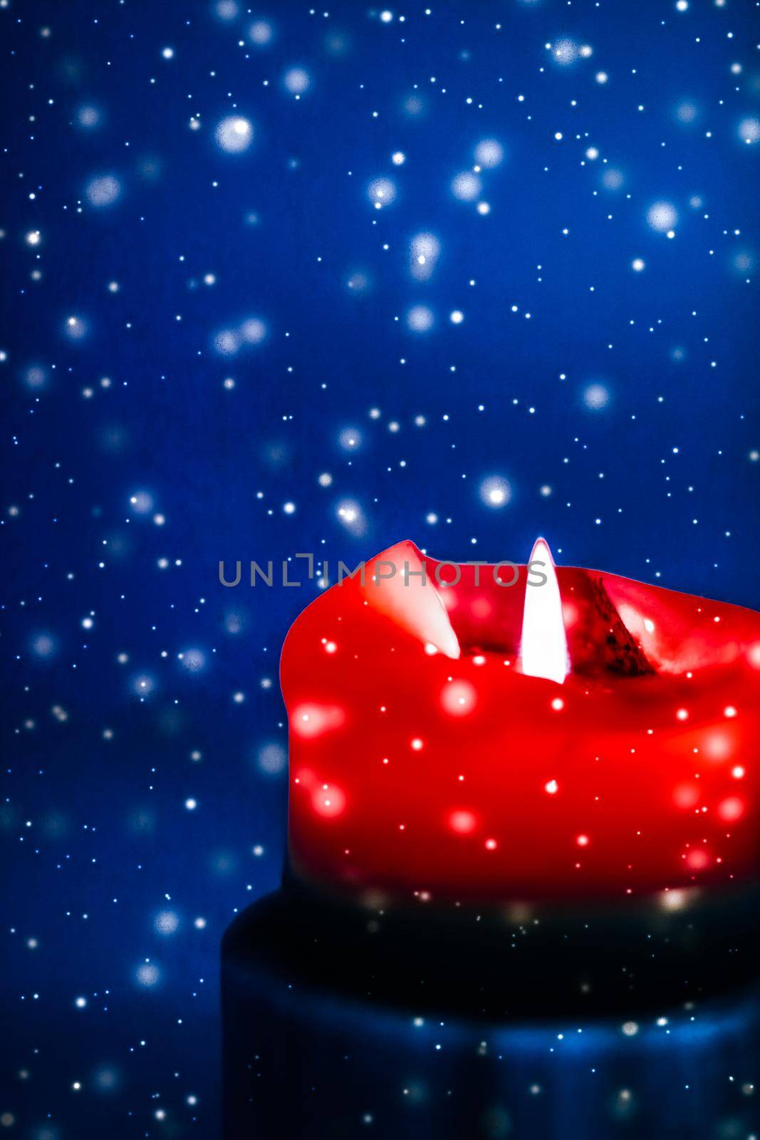 Happy holidays, greeting card and winter season concept - Red holiday candle on blue sparkling snowing background, luxury branding design for Christmas, New Years Eve and Valentines Day