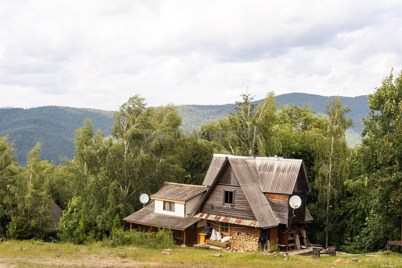 old wooden house in spring Carpathian mountains in Ukraine.