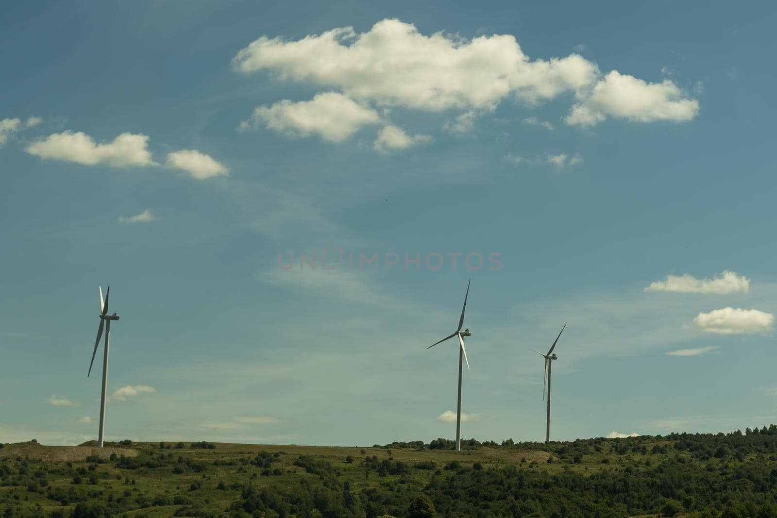 Power of wind turbine generating electricity clean energy with cloud background on the sky. Global ecology. by Andelov13