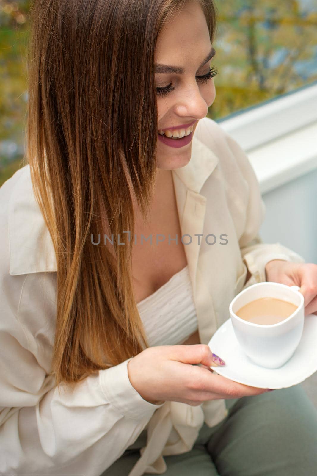 The young caucasian woman has a coffee and appointment with a female doctor in hospital office. by okskukuruza