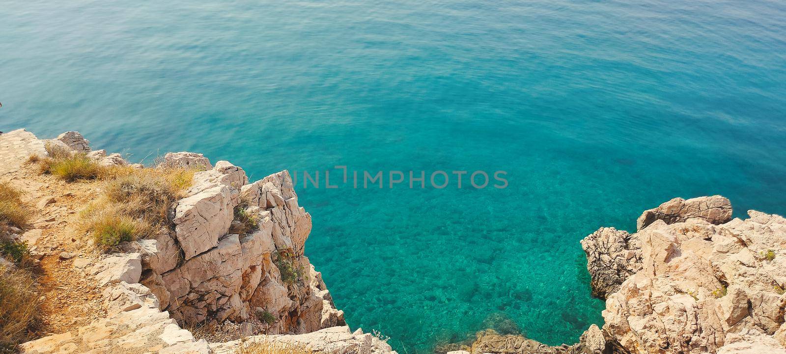 Ocean water with cliff from above, rocky beach . High quality photo