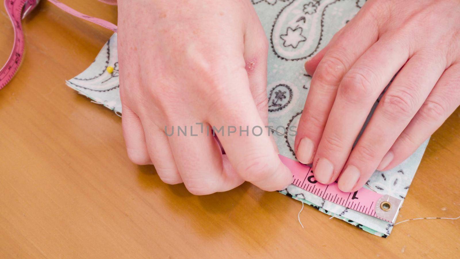 Sewing cotton face mask with a sewing machine for coronavirus outbreak.