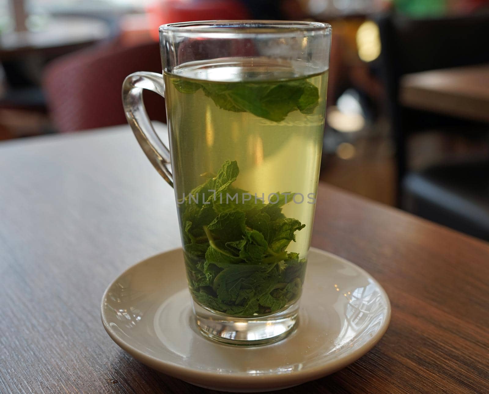 Transparent glass with hot fresh mint tea in a restaurant in Detmold, Germany