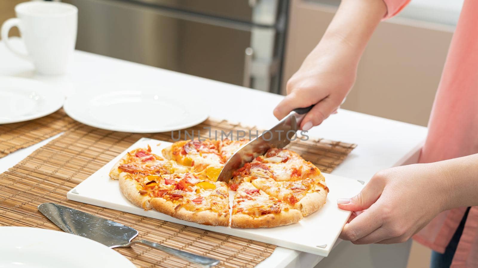 homemade pizza composition is cut with a kitchen knife by sdf_qwe
