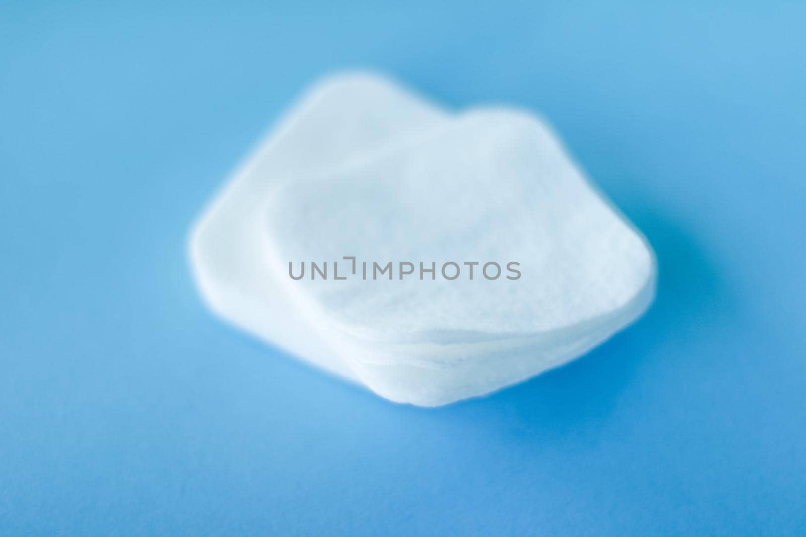 Cosmetology, cleanliness and branding concept - Organic cotton pads on blue background, cosmetics and make-up remover, hygiene and skincare beauty brand product for healthcare and medical design