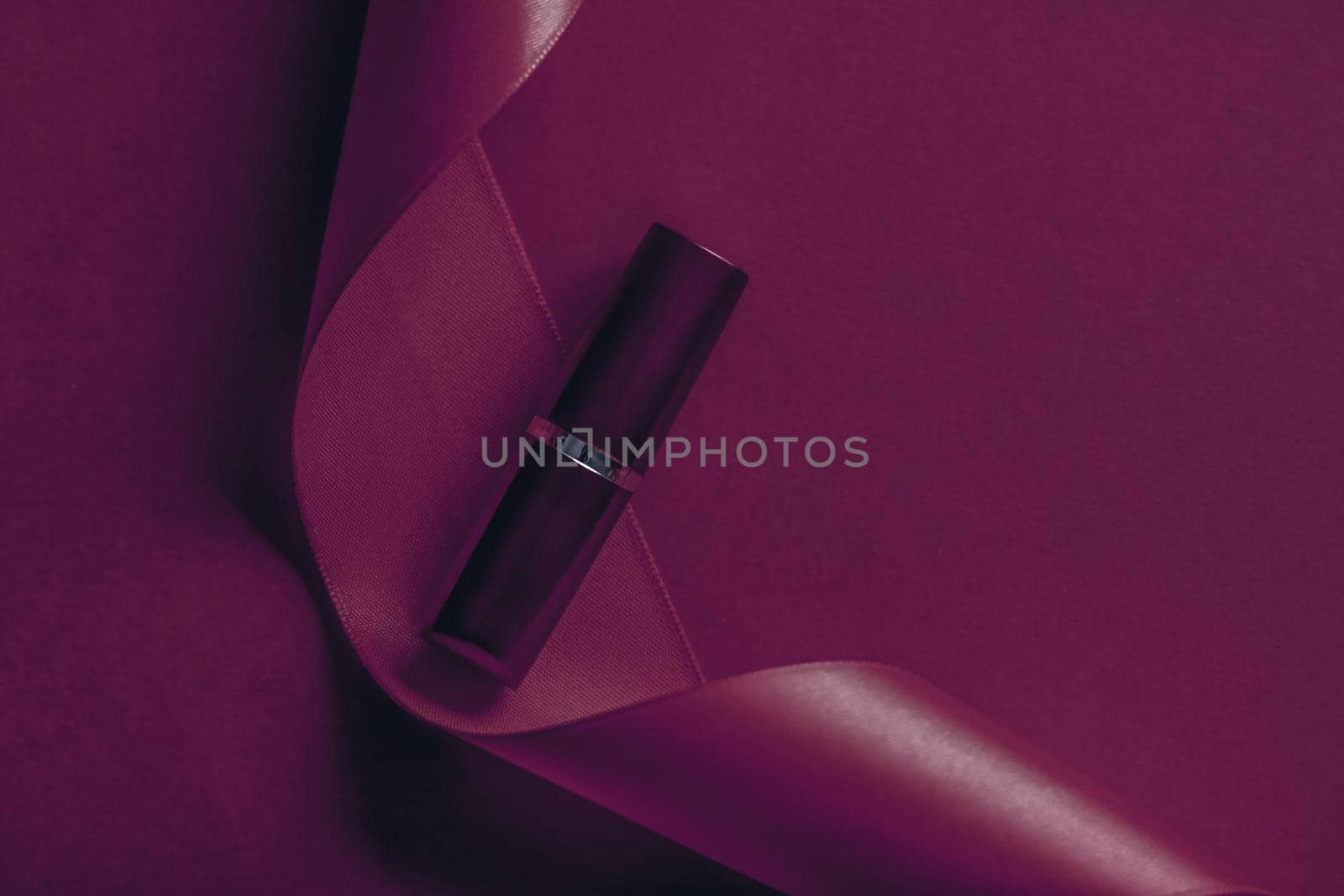 Cosmetic branding, glamour lip gloss and shopping sale concept - Luxury lipstick and silk ribbon on plum holiday background, make-up and cosmetics flatlay for beauty brand product design