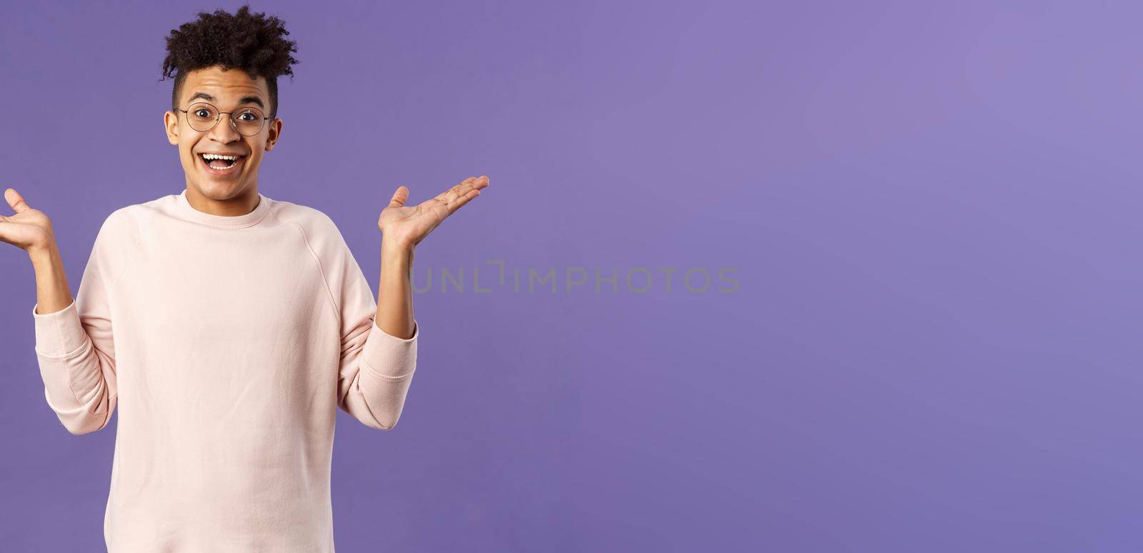 So what, I wear glasses. Portrait of unbothered, happy optimistic guy with dreads, wear round eyewear, shrugging carefree and raise hands sideways, smiling cheerful, have no worries.