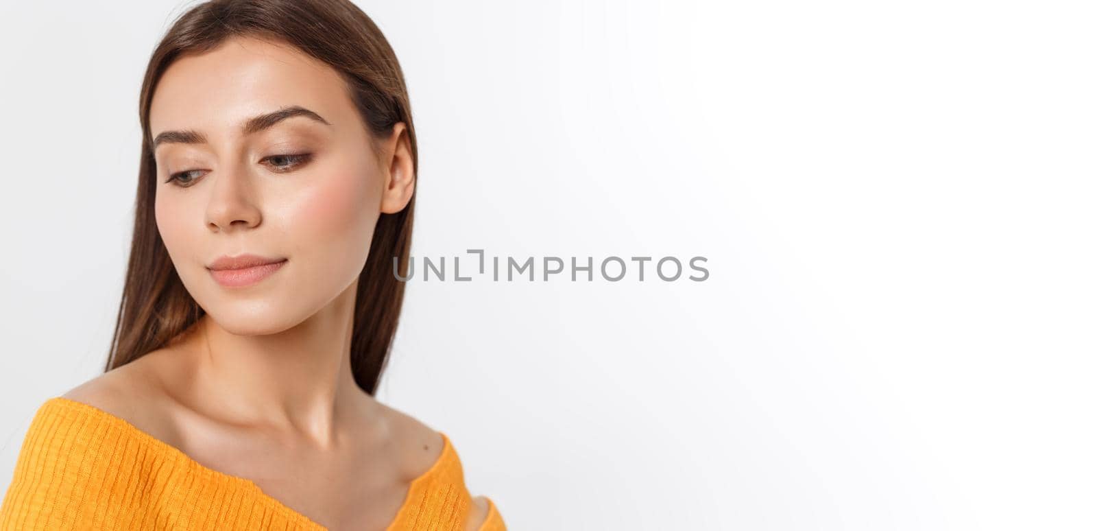 friendly smiling young woman with beatiful face portrait studio shot.