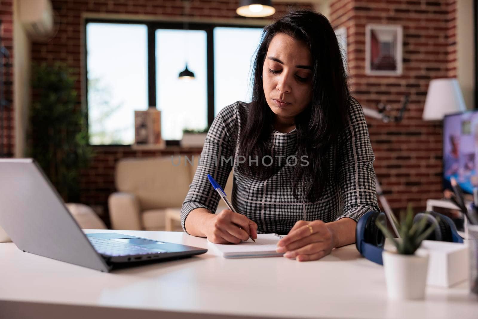 Indian worker taking paperwork notes by DCStudio