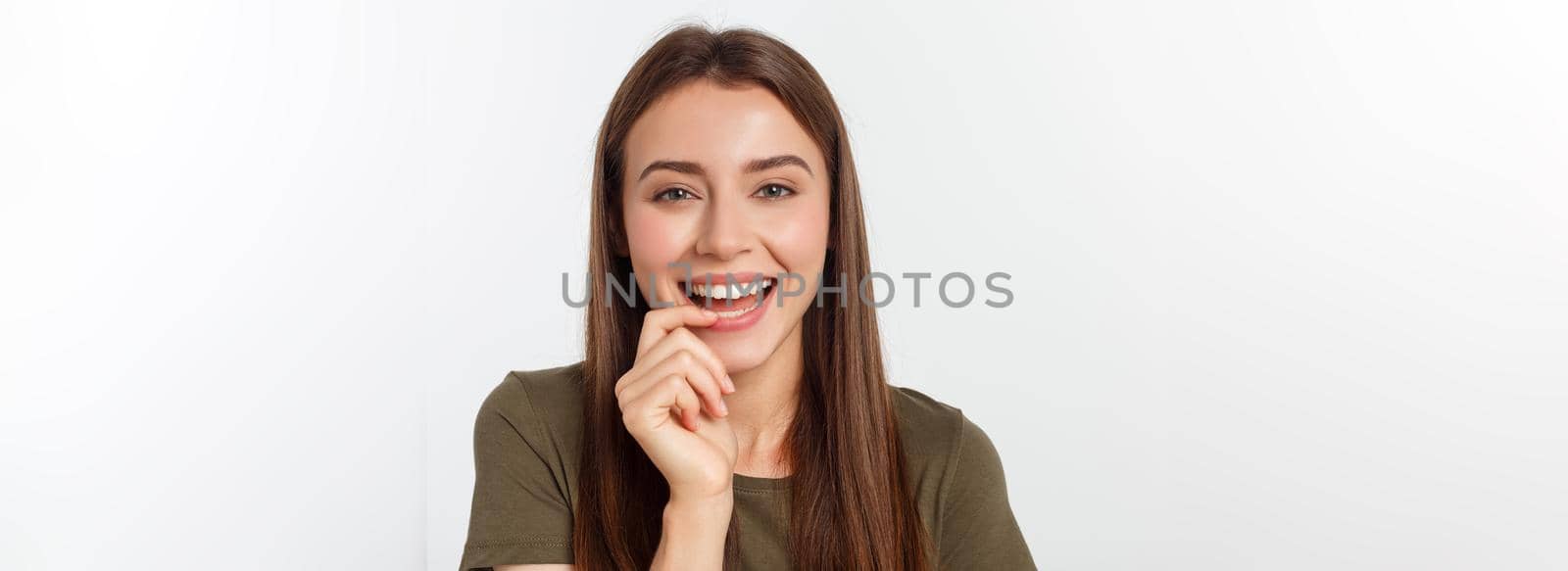 amazement - woman excited looking to the side. Surprised happy young woman looking sideways in excitement. Mixed race Asian and white Caucasian female model on grey background