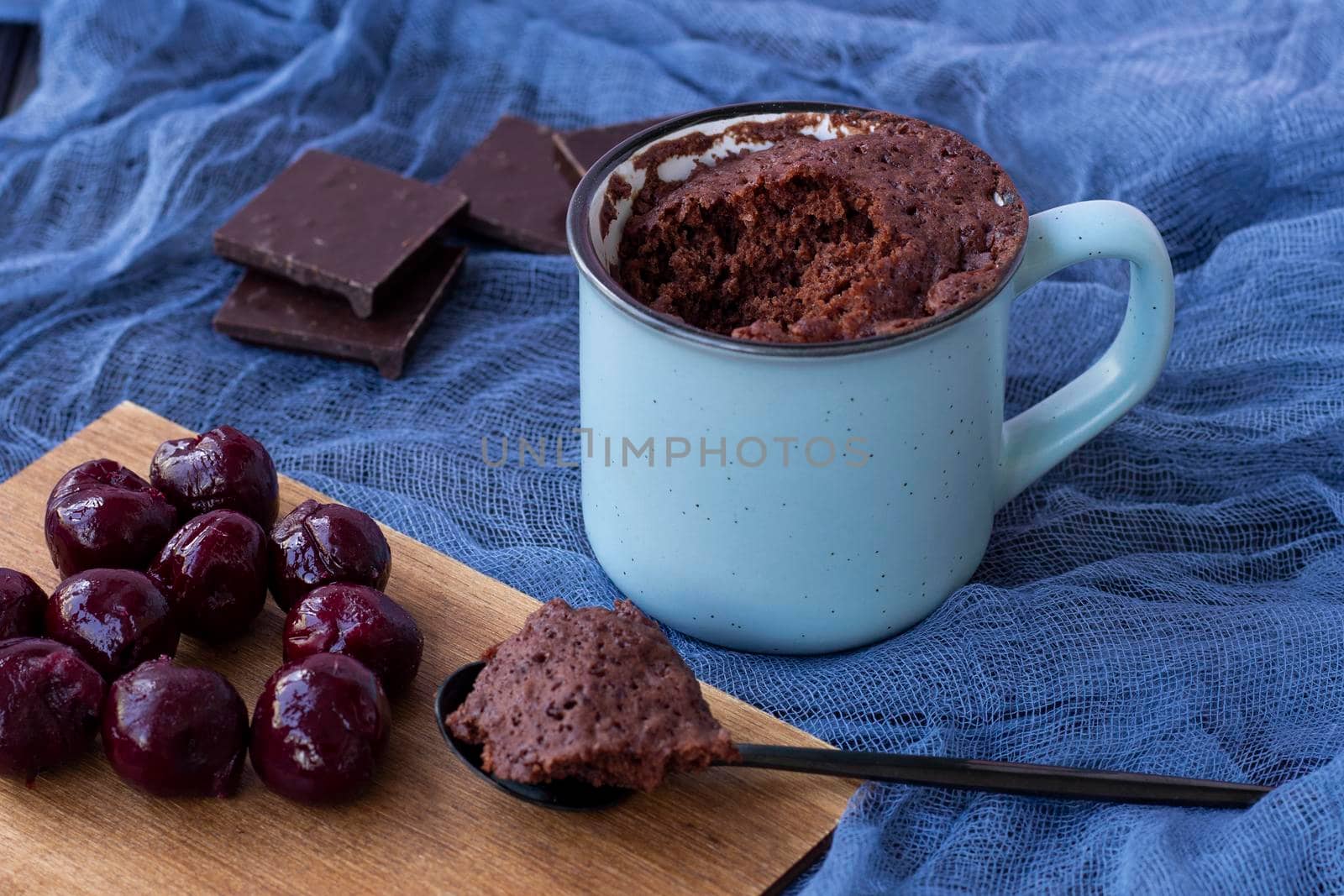 Brownie Chocolate Mug Cakes in cups on blue background. by Suietska