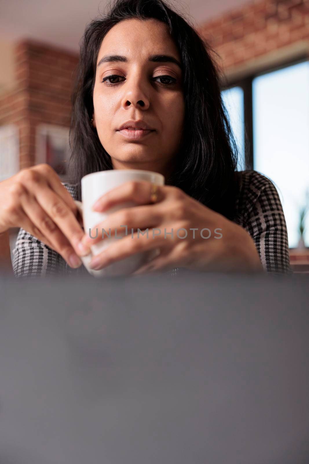 Female freelancer doing remote work on laptop by DCStudio