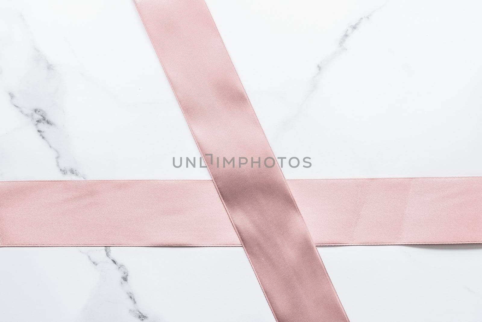 Beige silk ribbon and bow on marble background, glamour present mockup and fashion gift decoration for luxury beauty brand holiday flatlay design by Anneleven