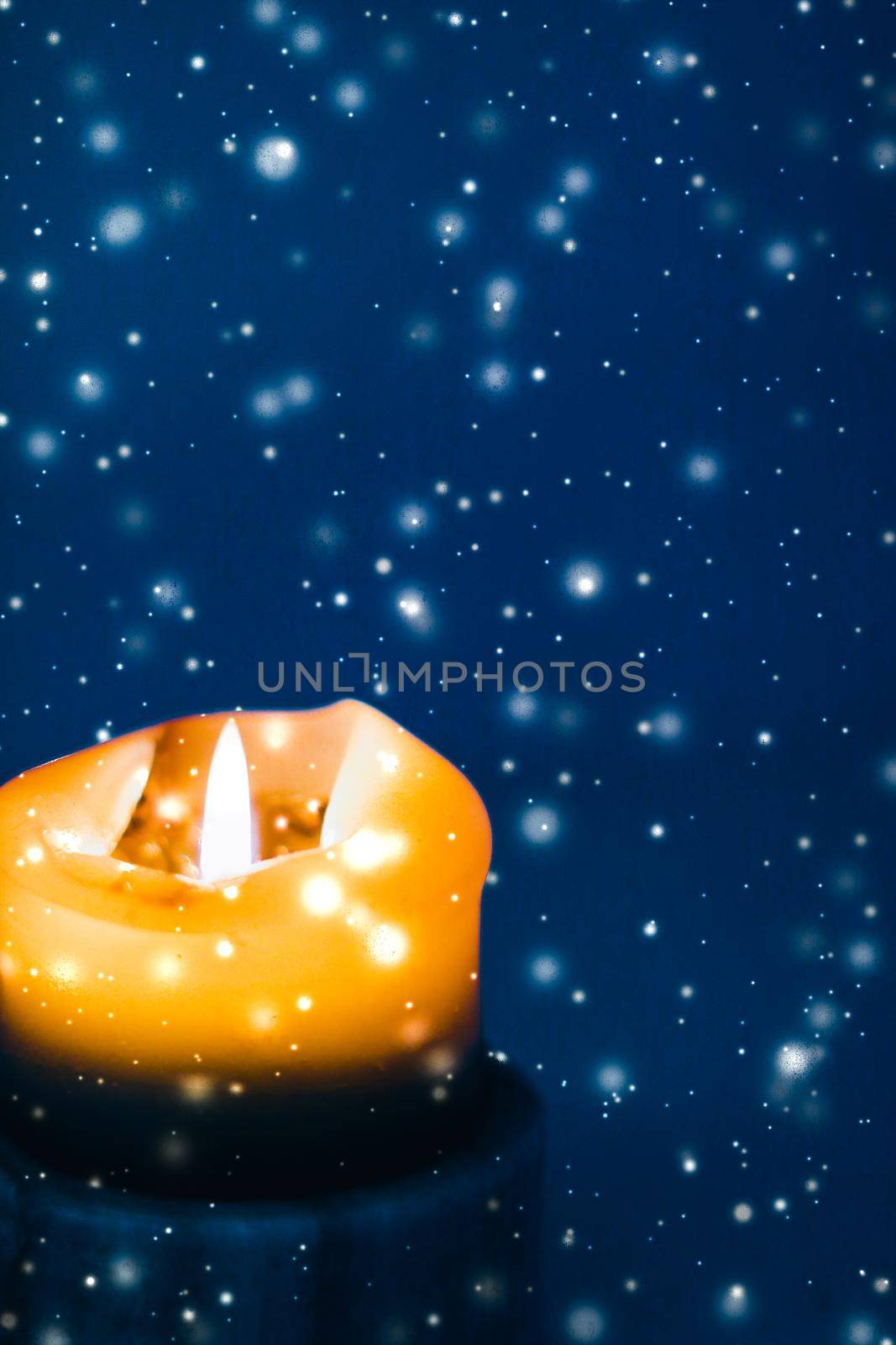 Happy holidays, greeting card and winter season concept - Yellow holiday candle on blue sparkling snowing background, luxury branding design for Christmas, New Years Eve and Valentines Day