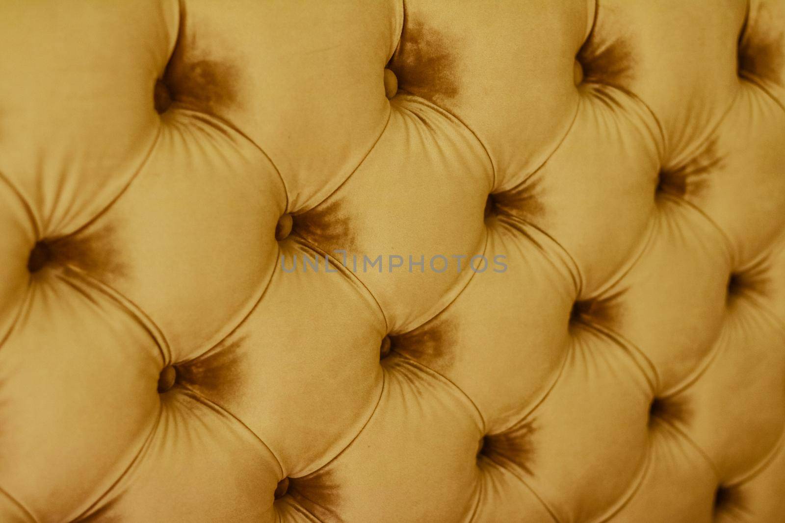 Golden luxury velour quilted sofa upholstery with buttons, elegant home decor texture and background by Anneleven