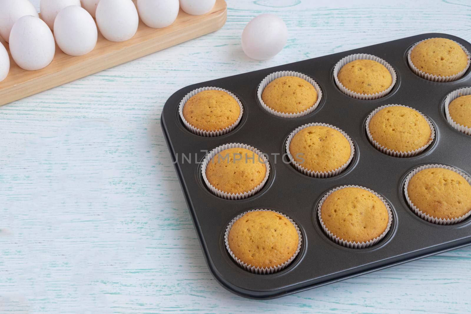 the vanilla muffins are cooled in a baking dish. Confectionery form. Fresh homemade baking concept. High quality photo. Freshly baked bran muffins cooling down in baking tin
