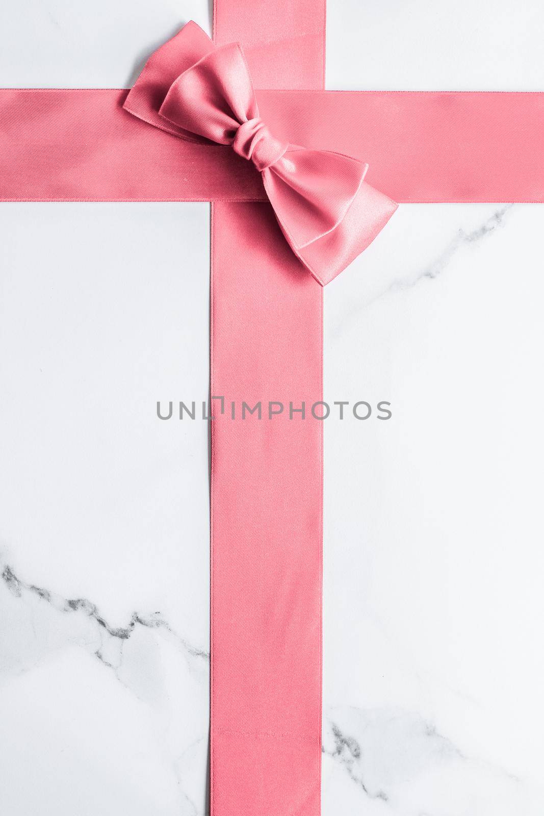 Birthday, wedding and girly branding concept - Coral silk ribbon and bow on marble background, girl baby shower present and glamour fashion gift decor for luxury beauty brand, holiday flatlay design