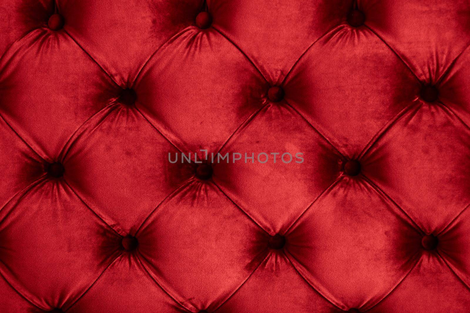 Red luxury velour quilted sofa upholstery with buttons, elegant home decor texture and background by Anneleven
