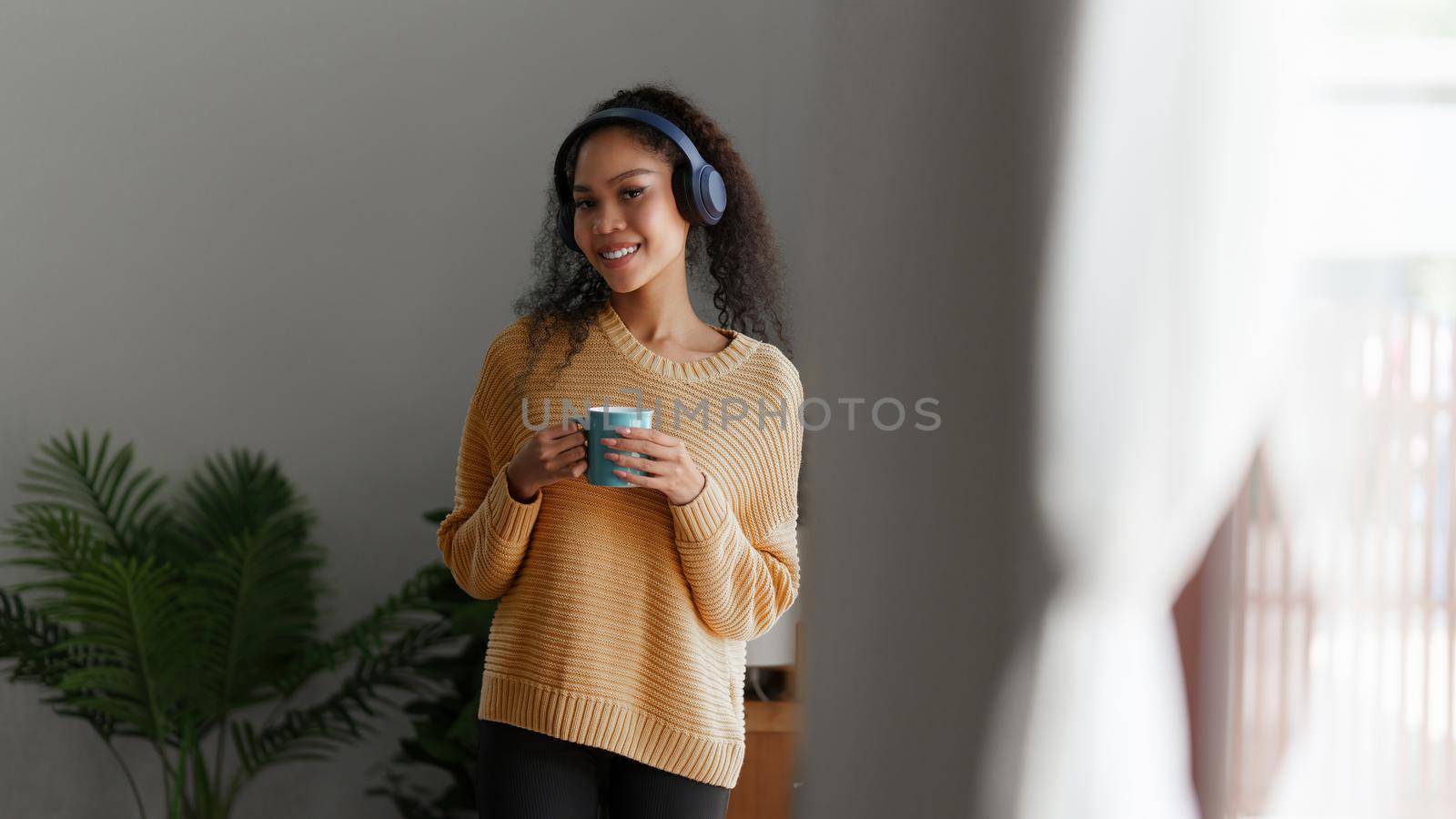 Beautiful woman relaxing and drinking coffee in morning at home.