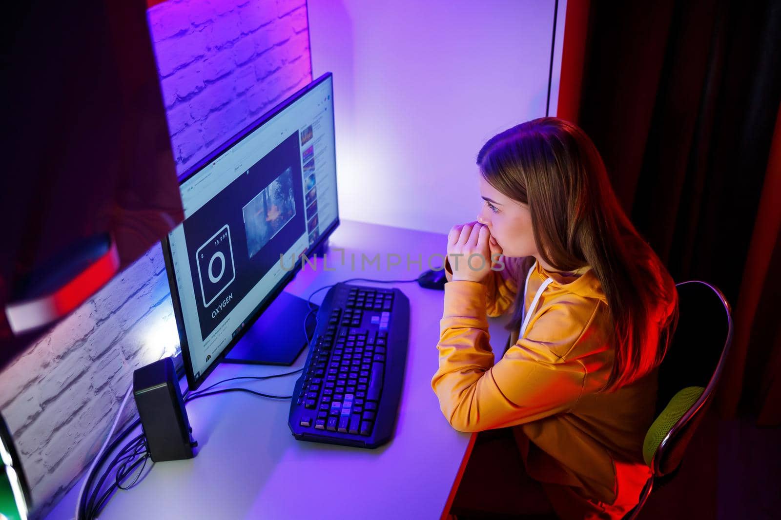 girl freelancer looks on the computer screen news about forest fires and the virus COVID-19