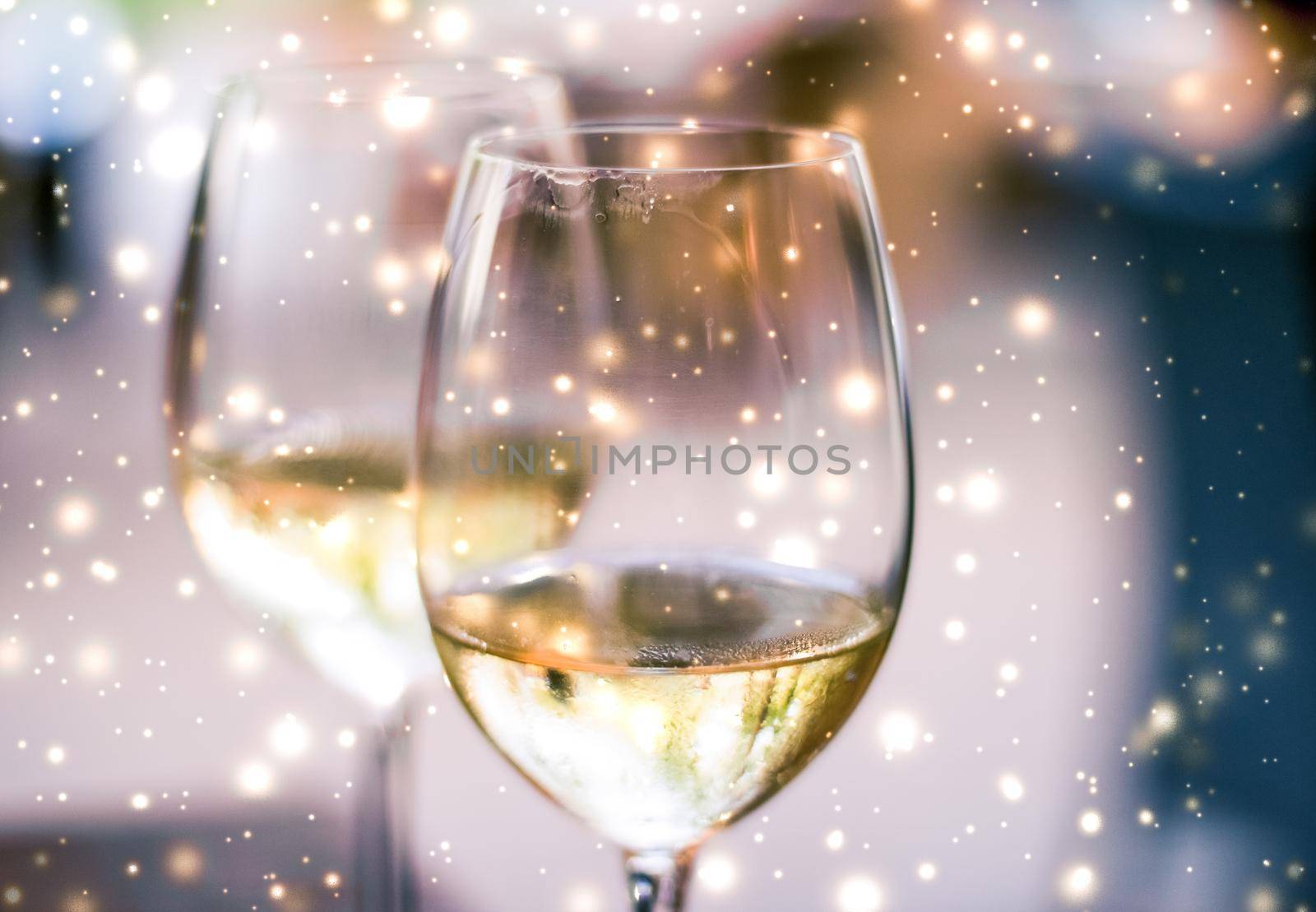 Winter holiday glasses of white wine and glowing snow on background, Christmas time romance by Anneleven