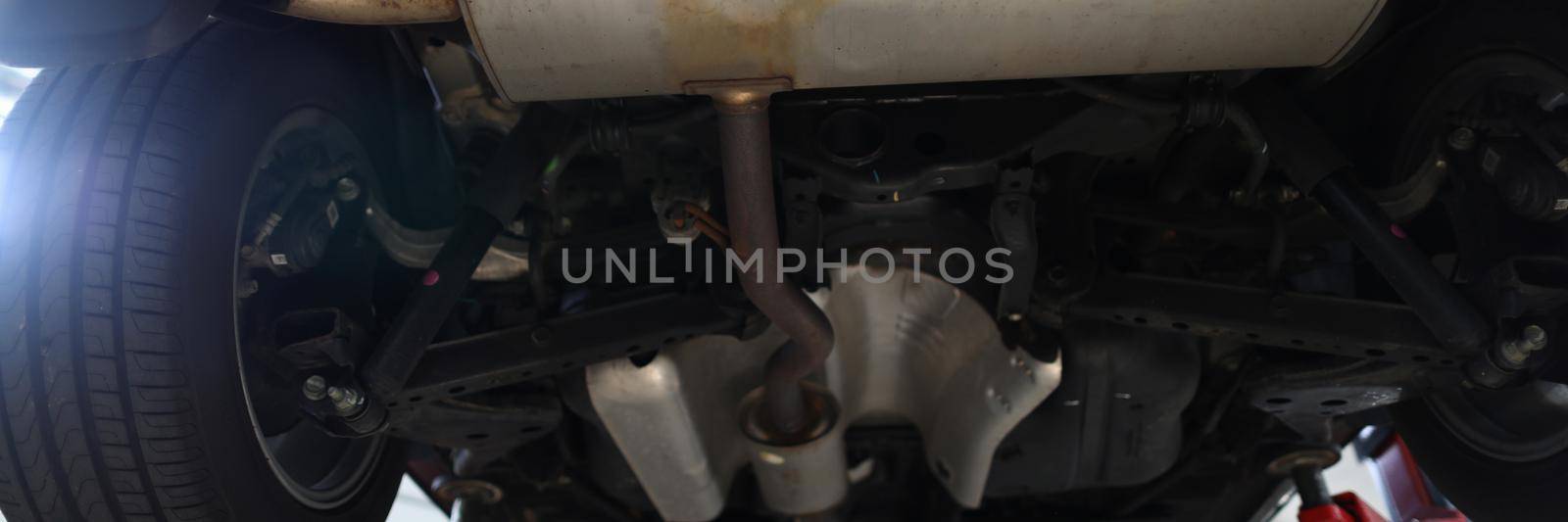 Bottom of car with muffler on lift by kuprevich