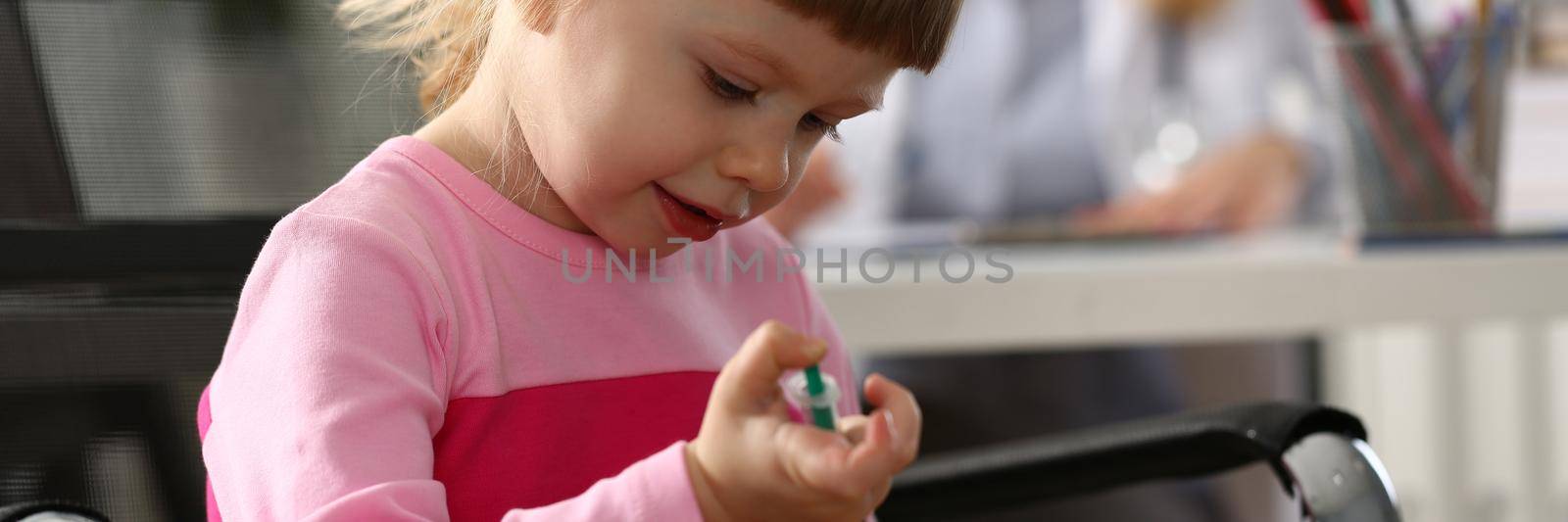 Little girl gives injection to toy closeup by kuprevich