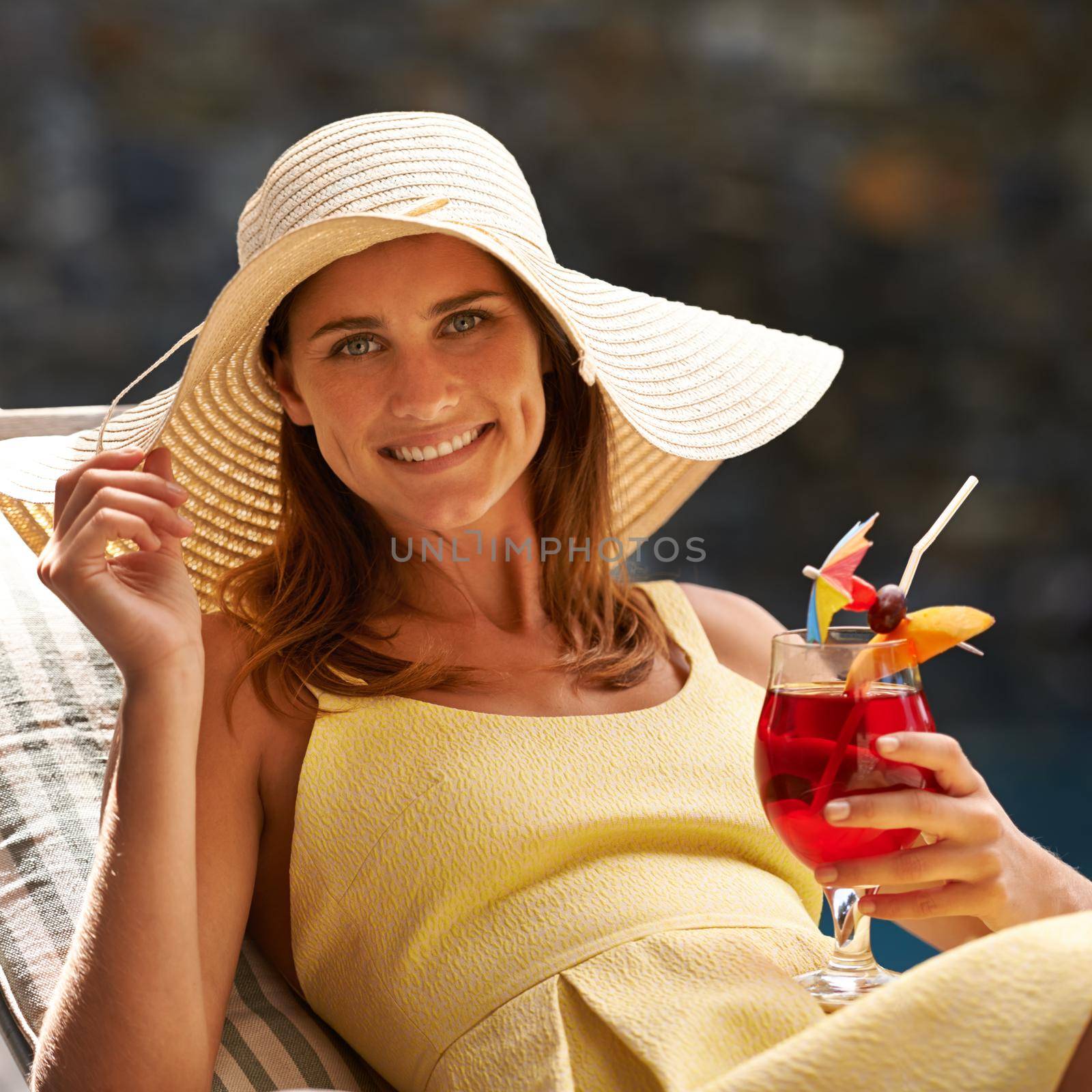 This is the life. A beautiful woman enjoying a drink and smiling outdoors