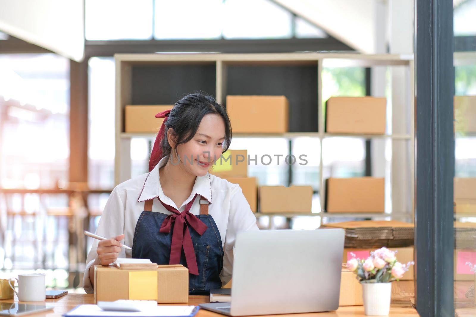 Starting small businesses SME owners female entrepreneurs check online orders to prepare to pack the boxes, sell to customers, sme business ideas online..