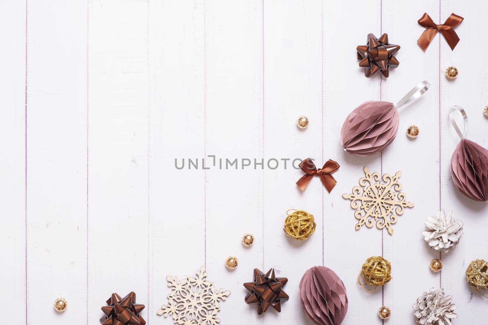 Festive creative christmas composition with paper Christmas balls and other eco friendly decor flat lay on wooden background.