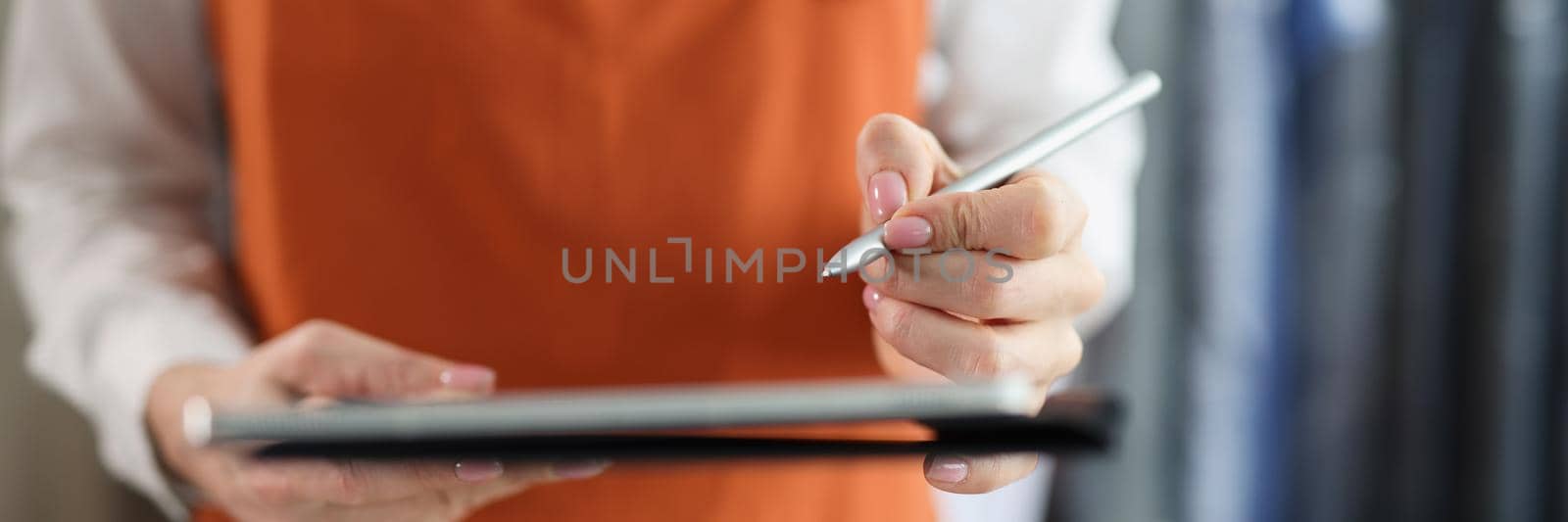 Tablet with stylus in female hands in uniform closeup by kuprevich
