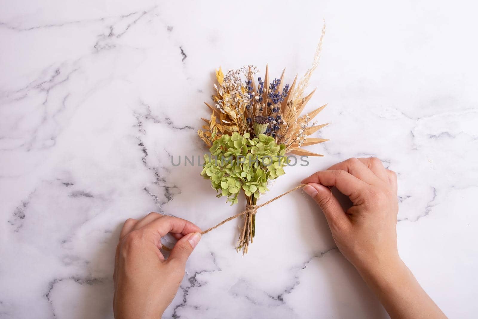 Making a bouquet of dry flowers and herbs